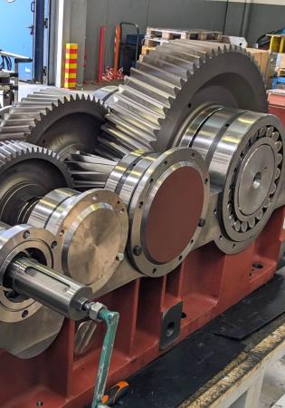 Parallel shaft gear reducer for large dam gate hoist with upper housing removed during final shop test and assembly steps.
