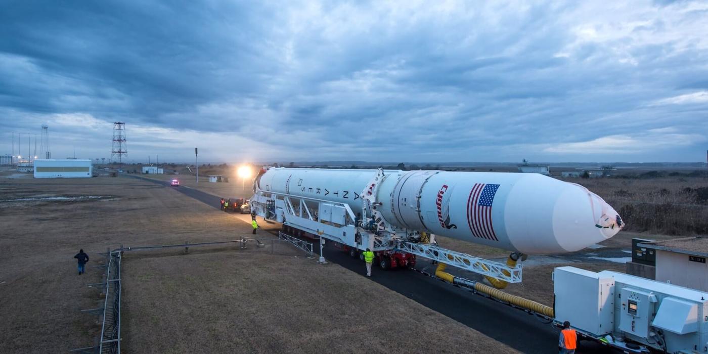 Antares rocket on TEL structure en route to pad 0A in dim light.