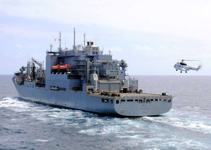 T-AKE-2 Dry cargo ship at sea being approached by a helicopter