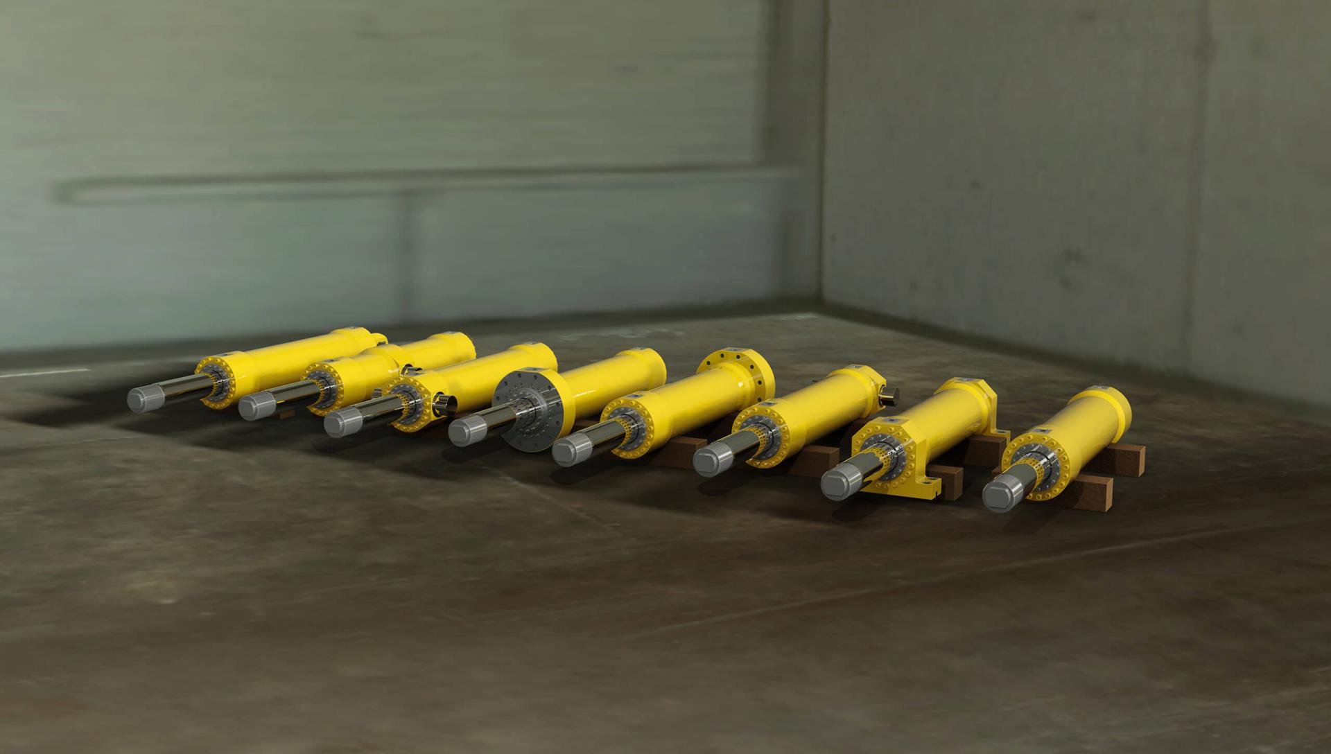 Several hydraulic cylinders on shop floor demonstrating examples of hydraulic cylinder mounts