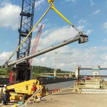 Long stroke hydraulic cylinder being lifted by a crane upon installation at a USACE navigational lock