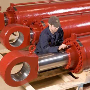 Technician inspecting large bore ship moonpool hydraulic cylinders and dredge hydraulic cylinders. 